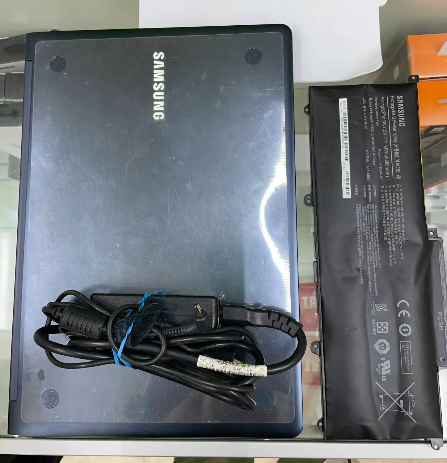 Samsung phone battery replacement in progress on a repair bench